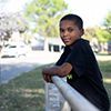 Elijah leaning on fence