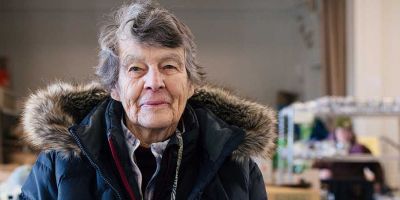 Mary from Massachusetts wearing a coat and smiling.