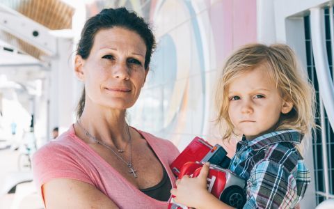 A woman holding her 3-year-old son.