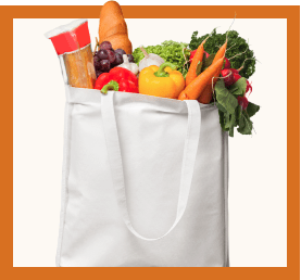 A grocery bag overflowing with fresh vegetables