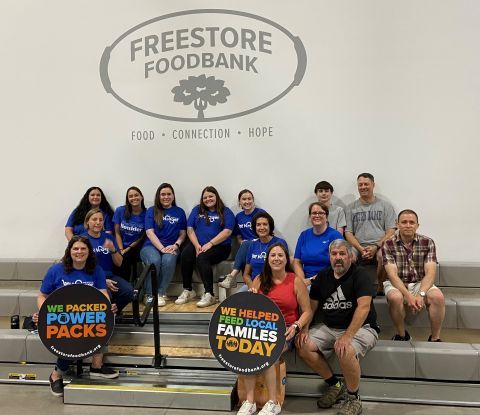 Kroger volunteers sitting on bleachers for a photo.