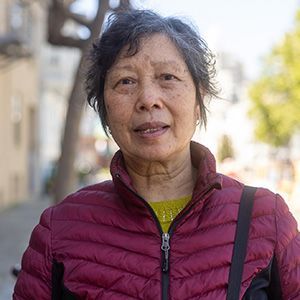 An older woman smiling at the camera.