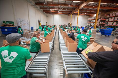 Starbucks volunteers packing boxes with food.