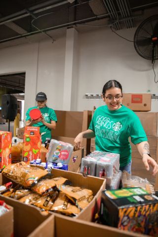 Starbucks volunteers sorting food in boxes.