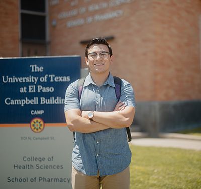 Thomas standing in front of a college building.